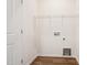 Convenient laundry room with a wooden floor and wire rack for storage at 865 Parc Townes Dr # 4, Wendell, NC 27591