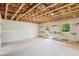 Unfinished basement with exposed ceiling and window offering potential for customization at 867 Parc Townes Dr # 3, Wendell, NC 27591