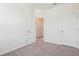 Neutral carpet fills the floor of this bedroom with white walls and trim and two white doors at 867 Parc Townes Dr # 3, Wendell, NC 27591