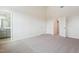 Spacious bedroom with neutral carpet, adjacent bathroom, and multiple doors leading to other rooms at 867 Parc Townes Dr # 3, Wendell, NC 27591