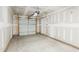 Spacious unfinished garage with concrete floor, drywall walls, garage door and a side entrance door at 867 Parc Townes Dr # 3, Wendell, NC 27591