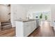 Modern kitchen island with stainless steel appliances, white cabinets, and hardwood flooring for open concept living at 867 Parc Townes Dr # 3, Wendell, NC 27591