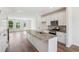 Bright kitchen features a granite island, stainless appliances, white cabinets, and hardwood floors for seamless entertaining at 867 Parc Townes Dr # 3, Wendell, NC 27591