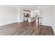 Open floor plan with hardwood floors, kitchen view with island, stairs, and ample natural light throughout the home at 867 Parc Townes Dr # 3, Wendell, NC 27591