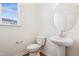 Stylish powder room with a pedestal sink, round mirror, and sleek fixtures at 867 Parc Townes Dr # 3, Wendell, NC 27591