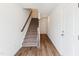 Hallway featuring hardwood flooring, a staircase, and white walls leading to bedrooms upstairs at 867 Parc Townes Dr # 3, Wendell, NC 27591