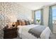 Cozy bedroom with patterned wallpaper, a comfortable bed, and natural light at 871 Parc Townes Dr # 1, Wendell, NC 27591