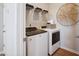 Functional laundry room with washer, dryer, and shelving at 871 Parc Townes Dr # 1, Wendell, NC 27591