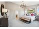 Bright and airy main bedroom featuring a comfortable bed, large artwork, and a sitting area at 871 Parc Townes Dr # 1, Wendell, NC 27591