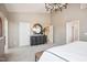 Spacious main bedroom with carpeted floors, large dresser, and an elegant chandelier at 871 Parc Townes Dr # 1, Wendell, NC 27591