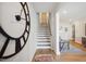 Elegant staircase with large clock and view of living area at 871 Parc Townes Dr # 1, Wendell, NC 27591
