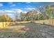 Large fenced backyard with a grassy area and trees at 1004 N Fayetteville Ave, Dunn, NC 28334