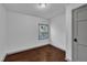 Minimal bedroom with natural light from window, fresh paint and hardwood flooring at 1004 N Fayetteville Ave, Dunn, NC 28334