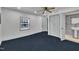 Bright bedroom with blue carpet, natural light, and adjacent bathroom at 1004 N Fayetteville Ave, Dunn, NC 28334
