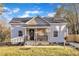 Newly renovated cottage with a charming front porch and well-manicured lawn at 1004 N Fayetteville Ave, Dunn, NC 28334