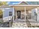 Inviting front porch with black railing and stone steps at 1004 N Fayetteville Ave, Dunn, NC 28334