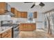 Bright kitchen features stainless appliances, updated cabinets, subway tile backsplash, and access to backyard at 1004 N Fayetteville Ave, Dunn, NC 28334