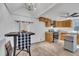 Open kitchen area blending dining and cooking spaces, with a vaulted ceiling and tile flooring at 1004 N Fayetteville Ave, Dunn, NC 28334