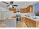 Open kitchen featuring stainless steel appliances, oak cabinets, tile flooring and stylish island at 1004 N Fayetteville Ave, Dunn, NC 28334