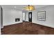 Cozy living room showcasing hardwood floors, fireplace, neutral paint, and a ceiling fan with lighting at 1004 N Fayetteville Ave, Dunn, NC 28334
