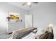 Stylishly decorated bedroom with a large bed, white dresser, and an open doorway at 1008 Ashton Oak Ct, Durham, NC 27703