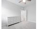 Neutral bedroom with light walls, neutral carpet, ceiling fan, and a white dresser at 1008 Ashton Oak Ct, Durham, NC 27703