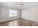 Bright bedroom with hardwood floors, ceiling fan, and natural light at 1008 Ashton Oak Ct, Durham, NC 27703
