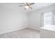 Bright bedroom with light walls, neutral carpet, ceiling fan and natural light from the window at 1008 Ashton Oak Ct, Durham, NC 27703