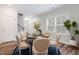 Inviting dining room features wood floors, a large window, and an elegant light fixture, ideal for entertaining at 1008 Ashton Oak Ct, Durham, NC 27703
