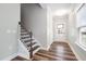 Foyer with hardwood floors, a staircase, and natural light from the front door window at 1008 Ashton Oak Ct, Durham, NC 27703