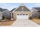 Charming single-Gathering home featuring a two-car garage and manicured front yard at 1008 Ashton Oak Ct, Durham, NC 27703