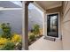 Inviting front porch area with landscaped garden beds and stylish front door entrance at 1008 Ashton Oak Ct, Durham, NC 27703
