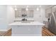 Kitchen featuring a center island, gray cabinets, stainless steel appliances, and modern lighting at 1008 Ashton Oak Ct, Durham, NC 27703