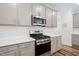 Updated kitchen with stainless steel appliances, white subway tile backsplash, and sleek countertops at 1008 Ashton Oak Ct, Durham, NC 27703