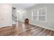 Bright, inviting living room with hardwood floors, natural light and neutral paint at 1008 Ashton Oak Ct, Durham, NC 27703