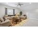 Cozy living room features neutral tones, plush seating, ceiling fan and bright natural light at 1008 Ashton Oak Ct, Durham, NC 27703