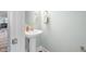 Charming powder room with pedestal sink, round mirror, and neutral paint at 1008 Ashton Oak Ct, Durham, NC 27703