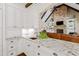 Island kitchen with white cabinets, granite counters, and a farmhouse sink at 1009 Northshore Dr, Wake Forest, NC 27587