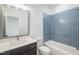 Bathroom with blue tiled walls, bathtub, and vanity at 126 Sanderway Dr, Chapel Hill, NC 27516