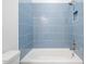 Bathroom with blue tiled walls and bathtub at 126 Sanderway Dr, Chapel Hill, NC 27516