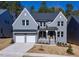 Two-story house with gray siding, two-car garage, and landscaping at 126 Sanderway Dr, Chapel Hill, NC 27516