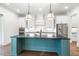 Modern kitchen with teal island and white cabinets at 126 Sanderway Dr, Chapel Hill, NC 27516
