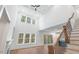 High-ceilinged living room with hardwood floors and a staircase at 126 Sanderway Dr, Chapel Hill, NC 27516