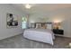 Main bedroom with plush bed, large window, and neutral tones creating a relaxing space at 1741 Old Fields Blvd, Haw River, NC 27258