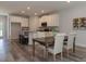Open concept dining room with hardwood floors and kitchen view at 1741 Old Fields Blvd, Haw River, NC 27258