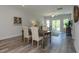 Open dining room with wood table and chairs, adjacent to living area at 1741 Old Fields Blvd, Haw River, NC 27258