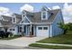 Exterior of charming two-story home with blue siding and brick accents at 1741 Old Fields Blvd, Haw River, NC 27258