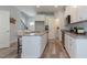 Bright kitchen featuring an island, white cabinets, and granite countertops at 1741 Old Fields Blvd, Haw River, NC 27258