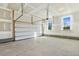 Unfinished two-car garage with concrete floor and automatic garage door at 181 Sage Ln, Four Oaks, NC 27524