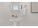 Modern bathroom featuring a pedestal sink, round mirror, and a neutral color palette at 216 Horseshoe Pl # 25, Angier, NC 27501